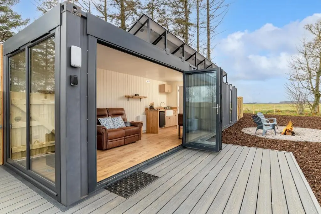 a large glass extension to a tiny house at The Off Grid Cabin in Insch
