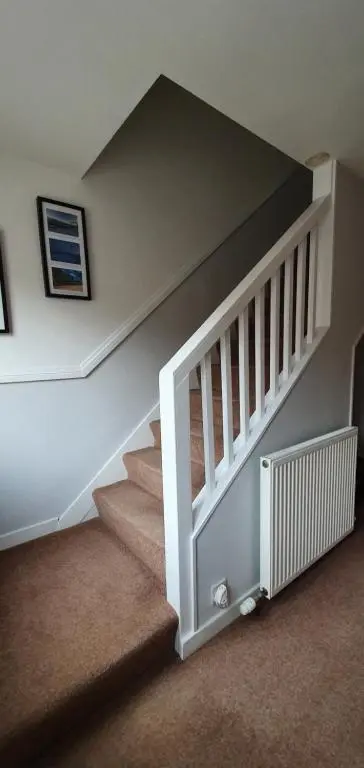 a staircase in a home with a stair case at York Street Retreat, modern cosy 2 bed with garden in Dufftown