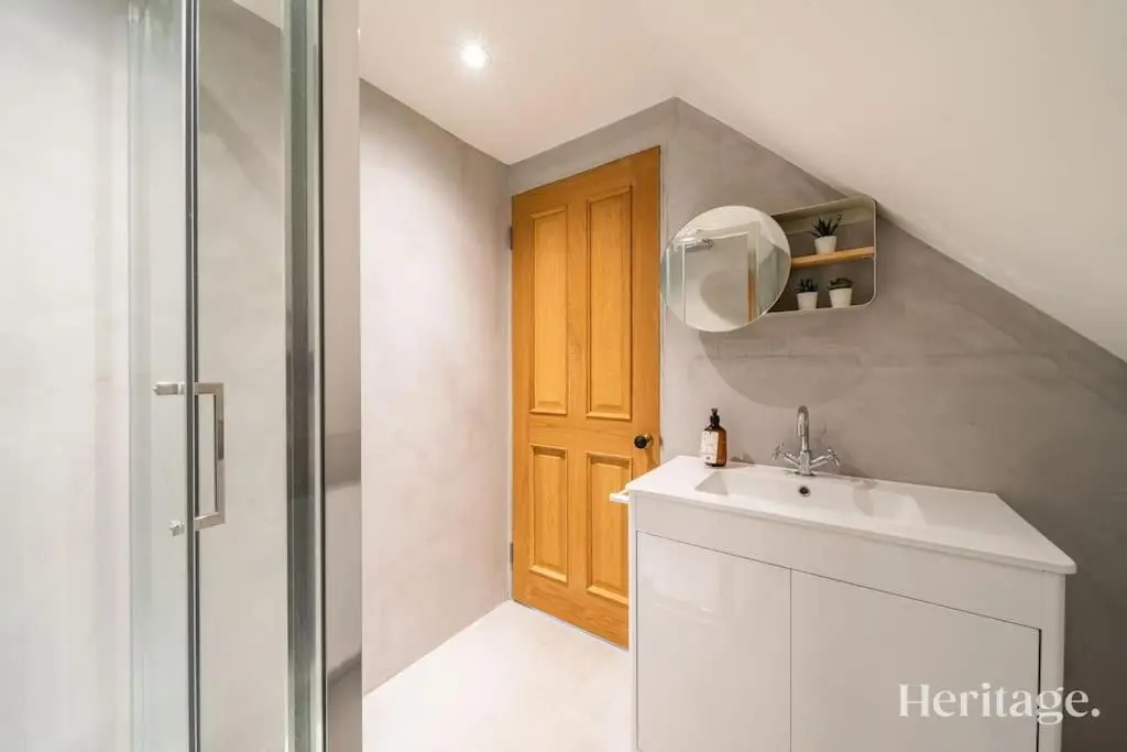 a bathroom with a sink and a wooden door at Kirkton Family Farmhouse with Hot Tub, Alford, Aberdeenshire in Alford