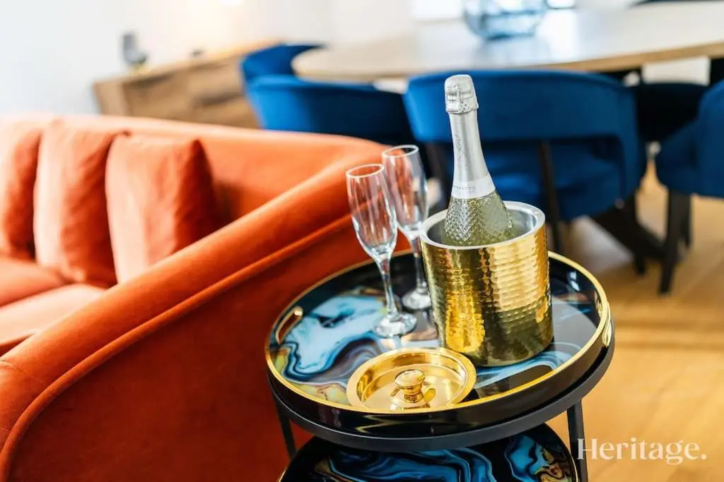 a table with a champagne bottle and glasses on it at Kirkton Family Farmhouse with Hot Tub, Alford, Aberdeenshire in Alford