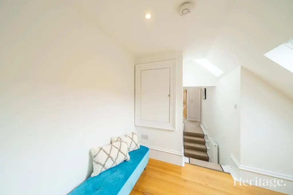 a living room with a blue couch and stairs at Kirkton Family Farmhouse with Hot Tub, Alford, Aberdeenshire in Alford