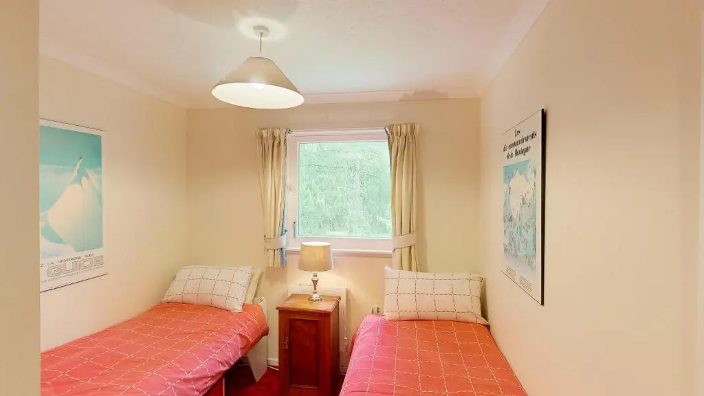 a bedroom with two beds and a window at Torr Beatha in Kincraig