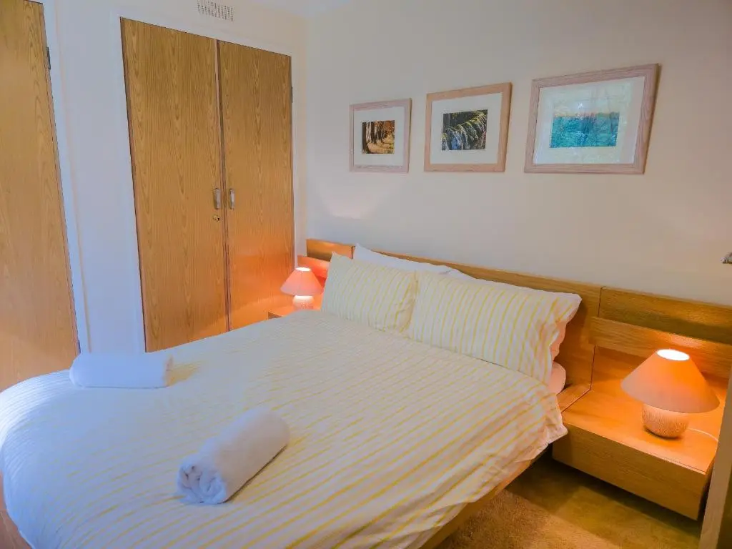 a bedroom with a bed with a white towel on it at Torr Beatha in Kincraig