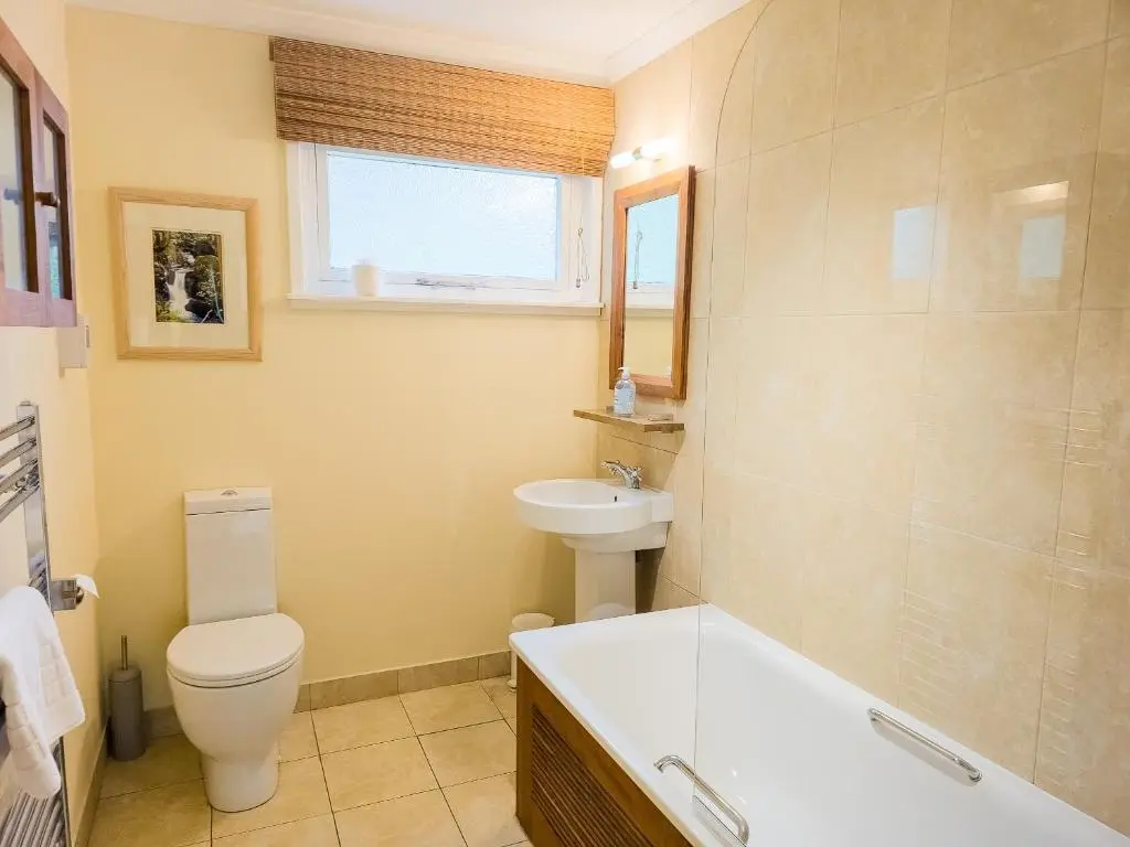 a bathroom with a toilet and a sink and a tub at Torr Beatha in Kincraig