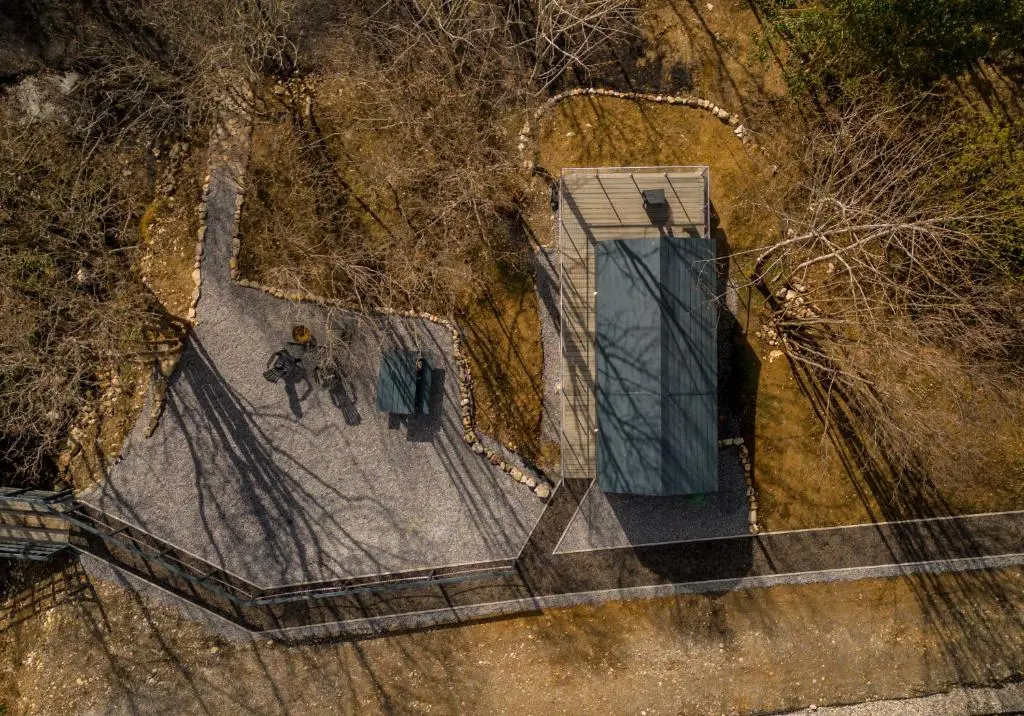an overhead view of a dog standing next to a building at Nessie Pod in Fort Augustus