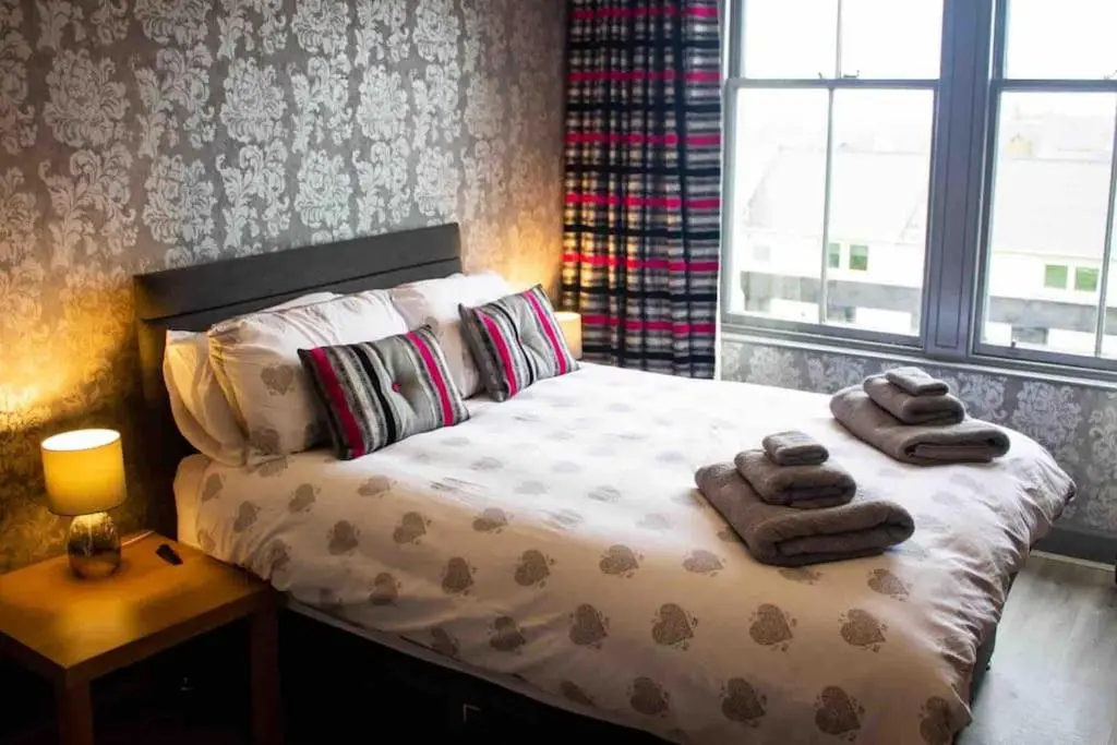 a bedroom with a bed with two towels on it at Crannoch Self Catering - 10 bedroom former hotel in Cullen