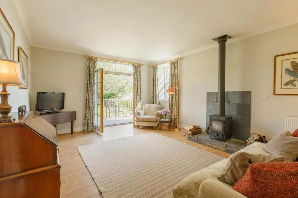 a living room with a couch and a fireplace at Little Fyrish in Evanton
