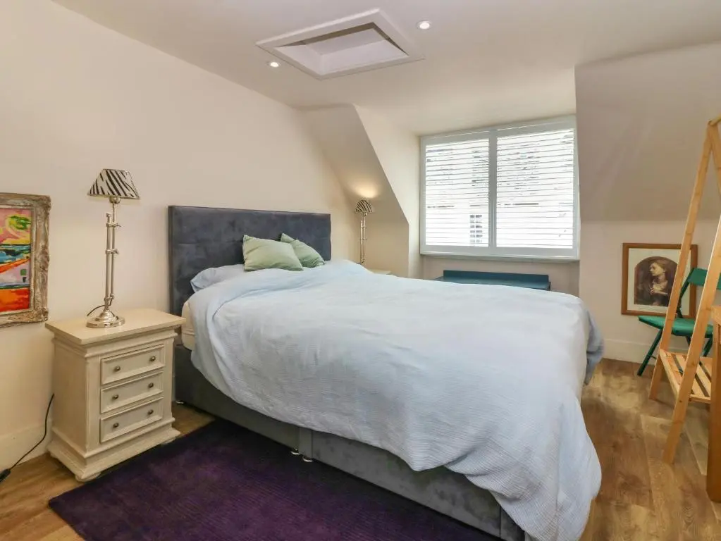 a bedroom with a large bed and a window at 1A Carmelite Street in Banff