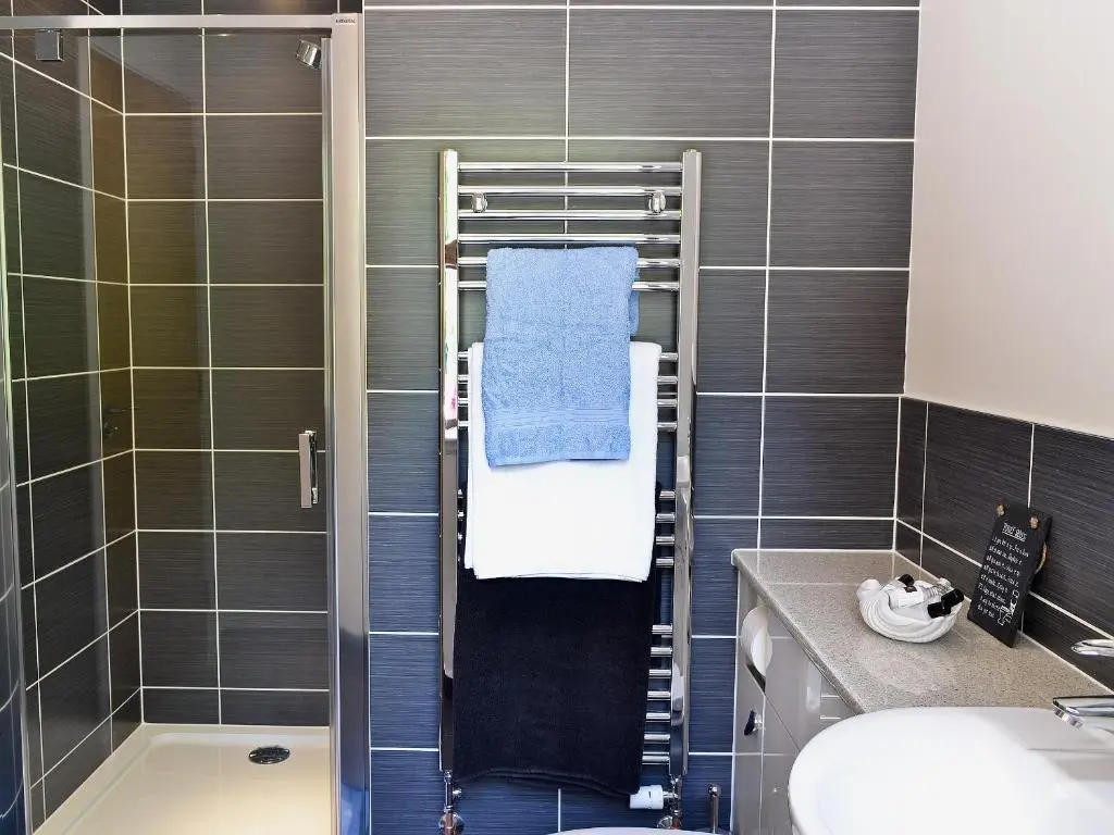 a bathroom with a towel rack and a shower at Mountshade in Finzean