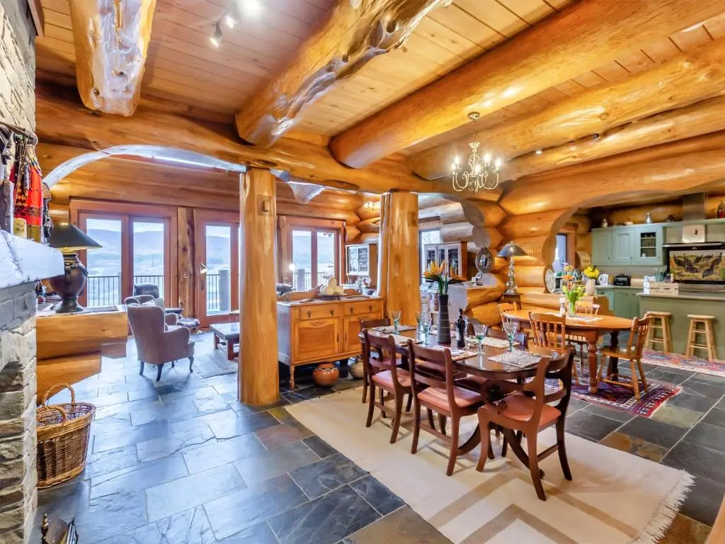 a kitchen and dining room with a table and chairs at Molalatau Lodge in Lairg