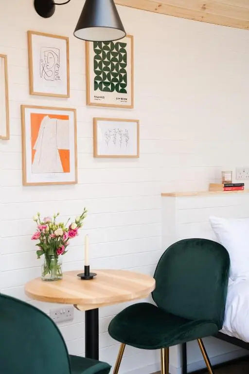 a bedroom with a table and two chairs and a bed at Willow's Nordic Shepherds Hut in Ballater