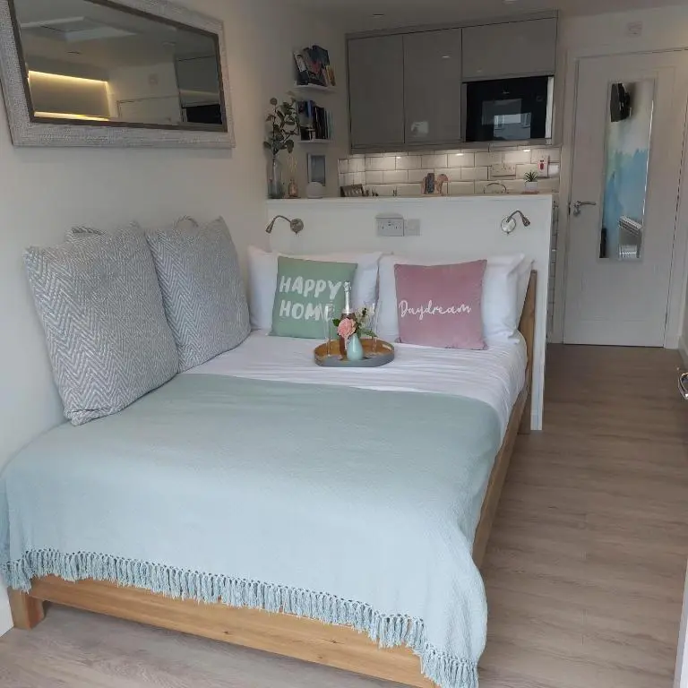 a bedroom with a bed with a happy momogram on it at The Snug - Cosy Retreat for Two in Inverness