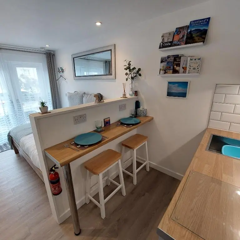 a small room with a table and a desk at The Snug - Cosy Retreat for Two in Inverness