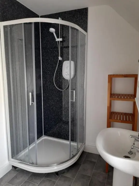 a bathroom with a shower and a sink at Culbokie Inn on the NC500 in Culbokie