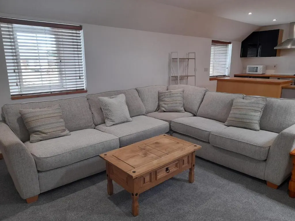 a living room with a couch and a coffee table at Culbokie Inn on the NC500 in Culbokie