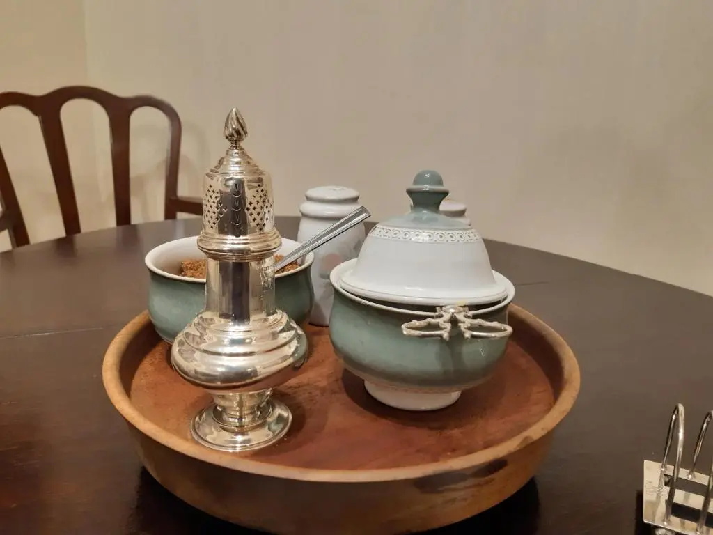 a table with three bowls and a tea set on it at Selkie House Song of the Sea in Helmsdale