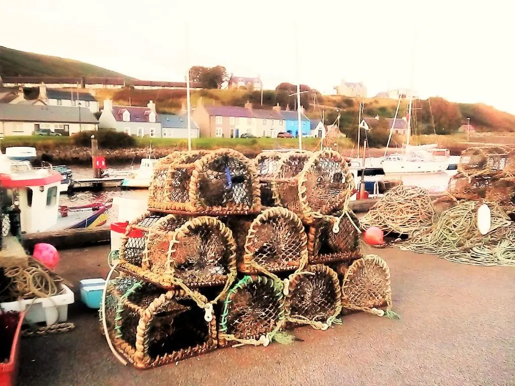 a pile of nets sitting on top of a marina at Selkie House Song of the Sea in Helmsdale