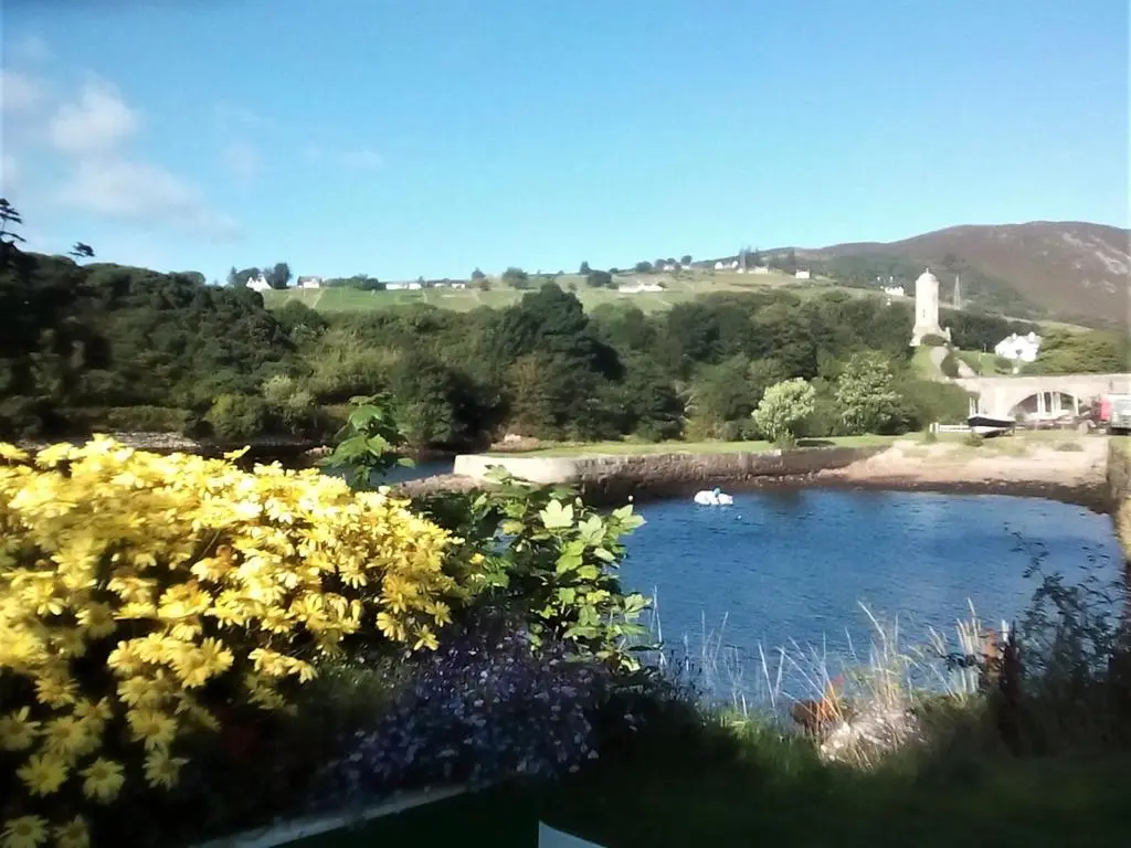 a view of a river with boats in it at Selkie House Sea Song in Helmsdale