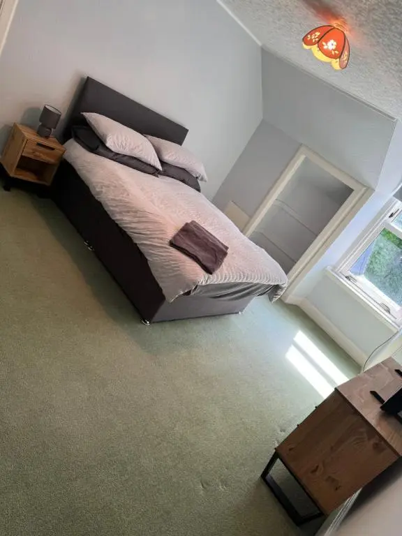 a bedroom with a bed and a window at Spacious Harbour House in Wick