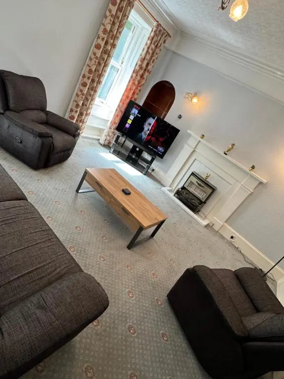 a living room with a couch and a coffee table at Spacious Harbour House in Wick