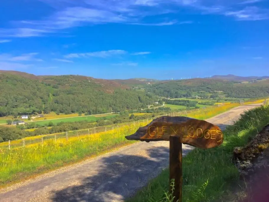 a sign on the side of a dirt road at Glen Lodges Rogart in Rogart