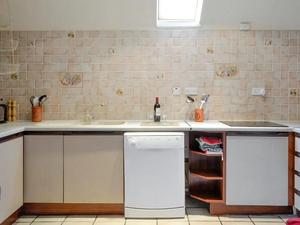 a kitchen with a sink and a dishwasher at Rowan Tree Cottage - S4216 in Tulchan