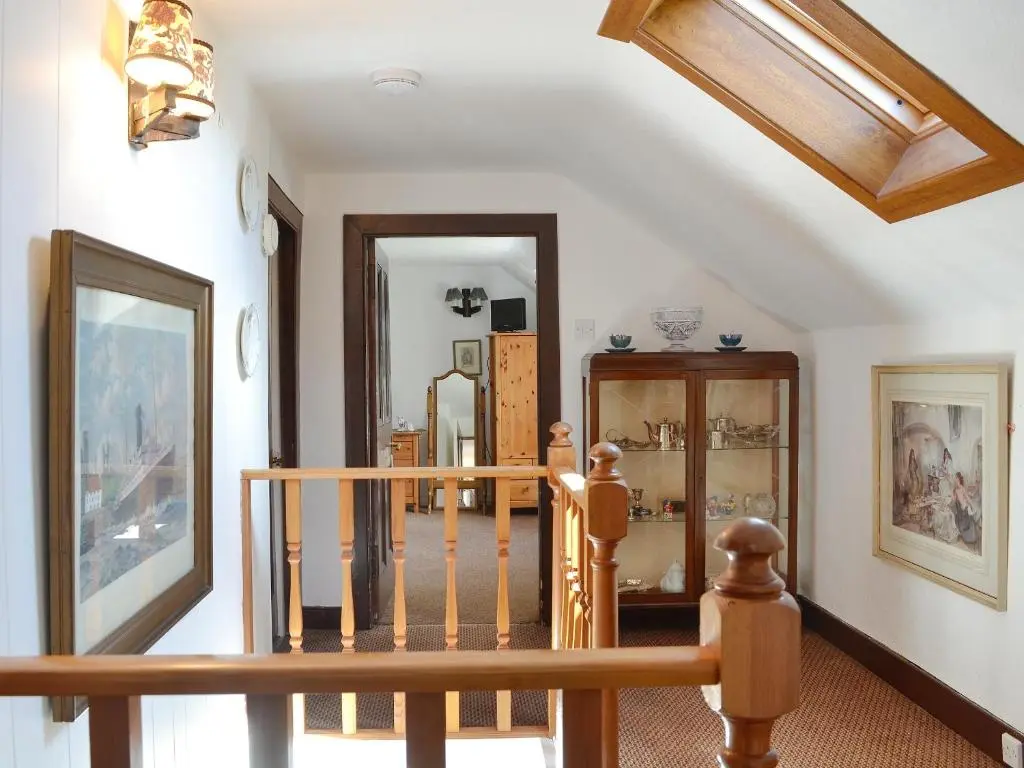 a staircase in a house with a wooden railing at Dalvanie Mill - S4241 in Tulchan