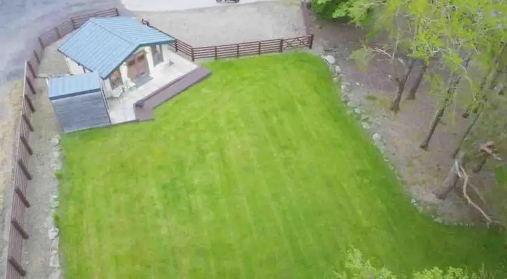 an overhead view of a large green yard with a house at Backieley Lodge in Huntly