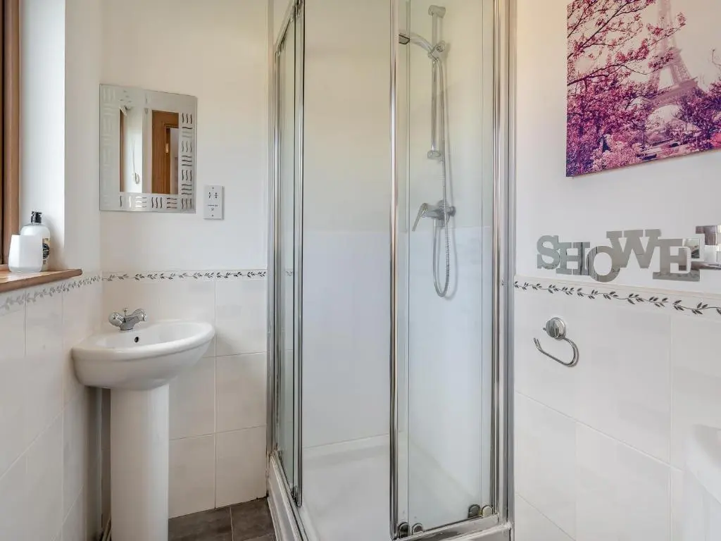 a bathroom with a shower and a sink at Croftside House - S4401 in Inverdruie