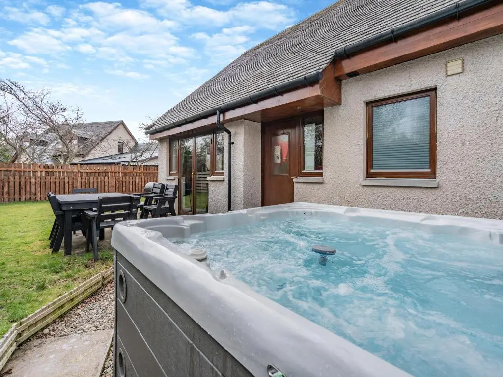 a hot tub in the backyard of a house at Cairn View - S4402 in Inverdruie