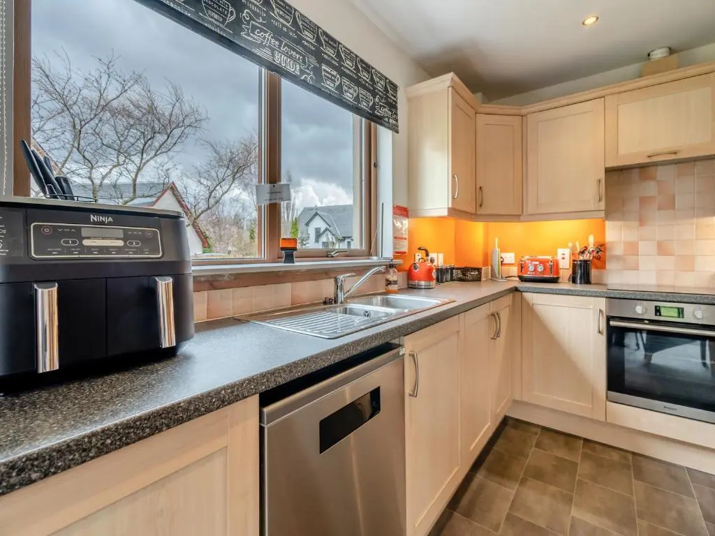 a kitchen with a sink and a window at Cairn View - S4402 in Inverdruie