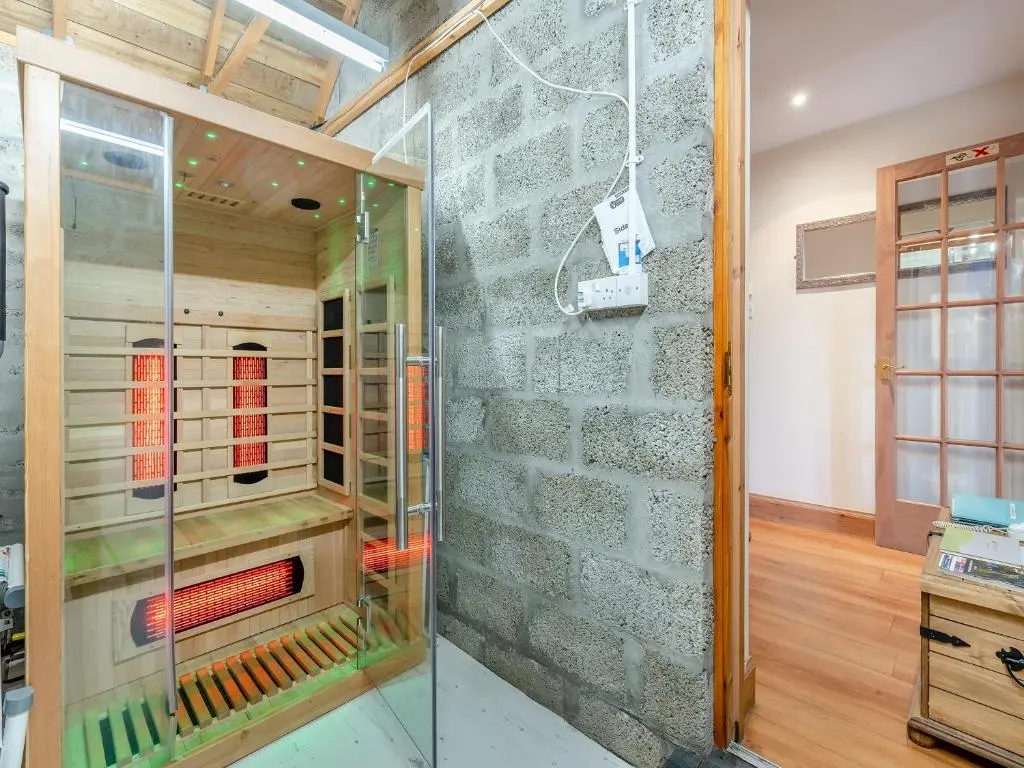 a glass display case in a room with a stone wall at Coire Cas - S4538 in Inverdruie