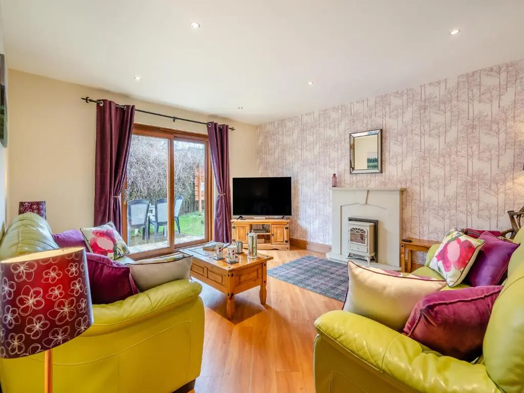 a living room with two couches and a fireplace at Coire Cas - S4538 in Inverdruie