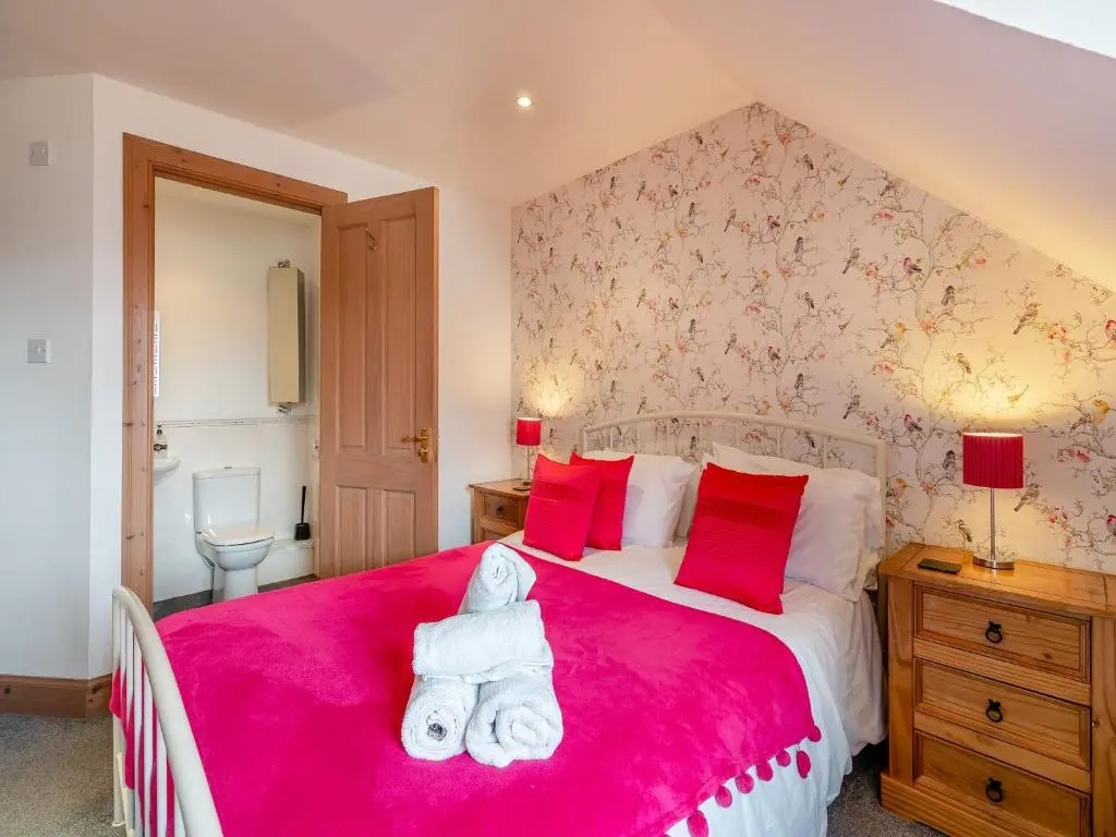 a bedroom with a red bed with a teddy bear on it at Coire Cas - S4538 in Inverdruie