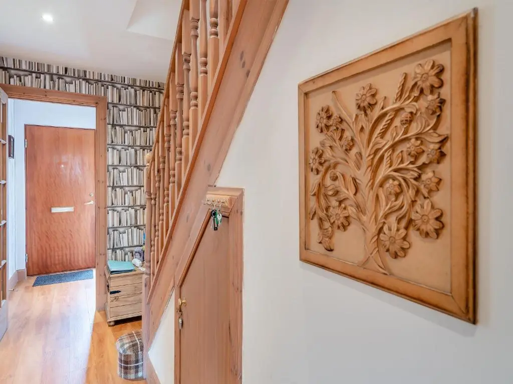 a hallway with a door and a picture on the wall at Coire Cas - S4538 in Inverdruie