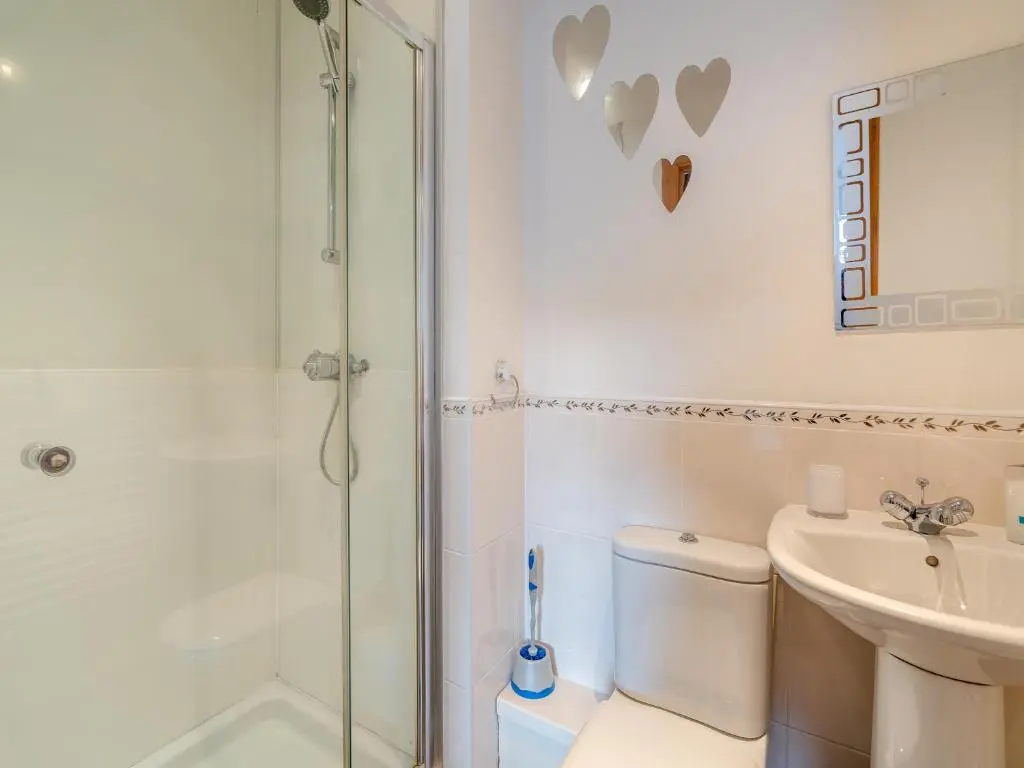 a bathroom with a shower and a toilet and a sink at Clunnie Mor - S4615 in Aviemore