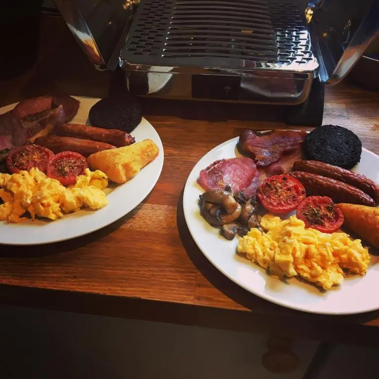 two plates of breakfast food on a table at Eriskay Guest House and Aviemore Glamping in Aviemore