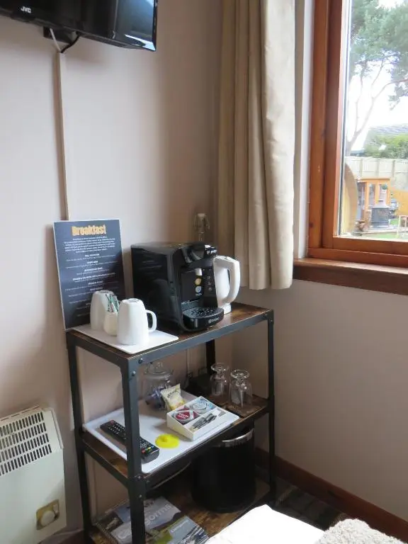 a small table with a microwave and a coffee maker at Eriskay Guest House and Aviemore Glamping in Aviemore
