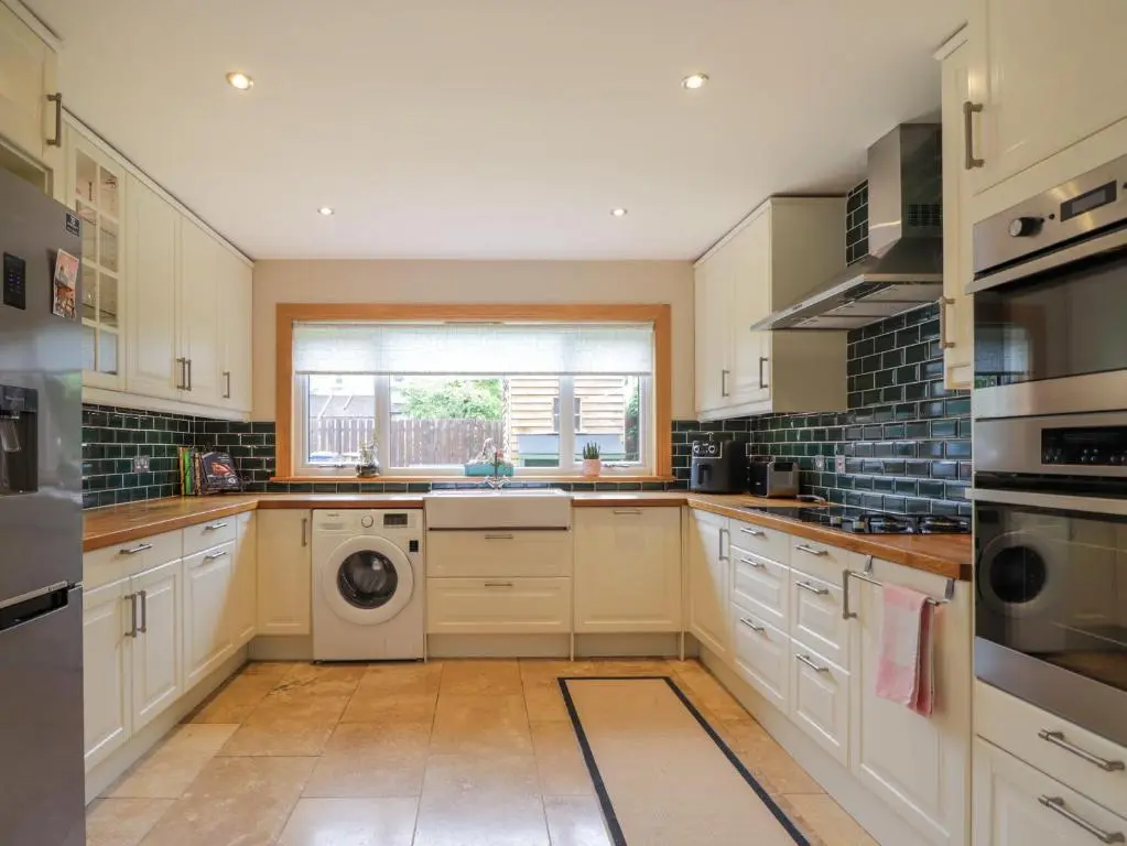 a kitchen with a washer and dryer in it at Garry Isle in Inverness