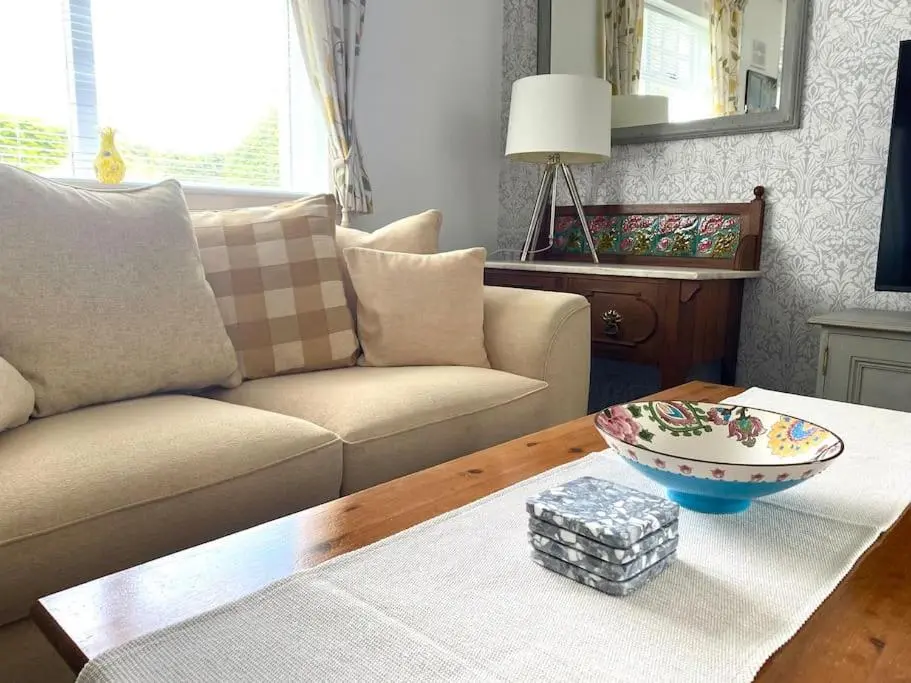 a living room with a couch and a table at Glenburn, Peaceful Accommodation Fochabers in Fochabers