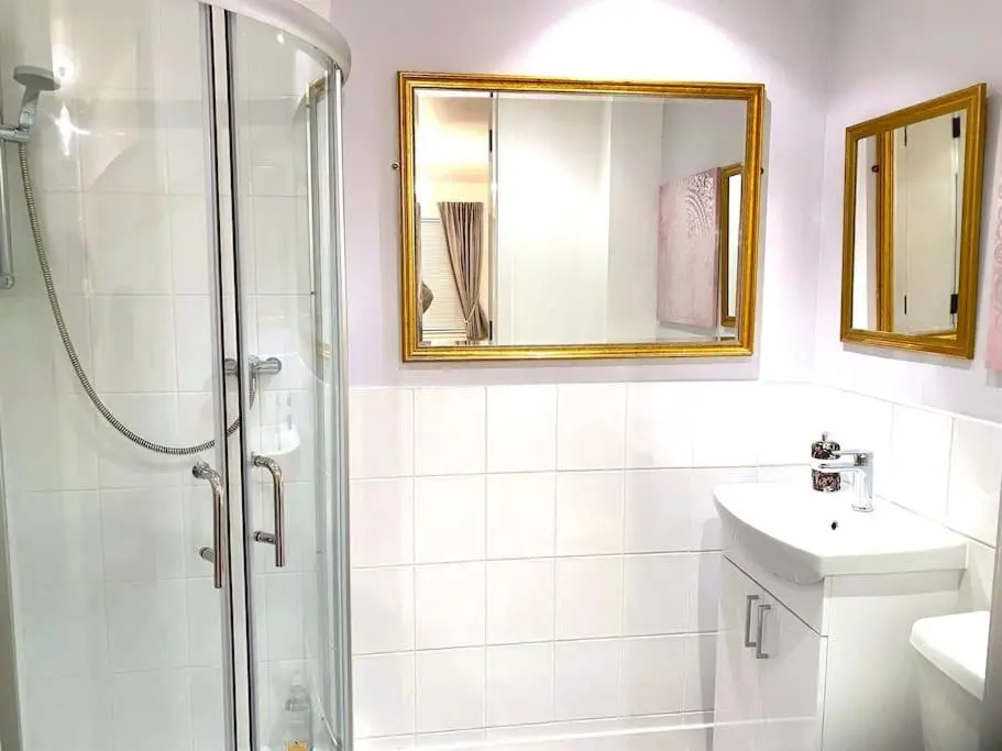 a bathroom with a shower and a sink and a mirror at Glenburn, Peaceful Accommodation Fochabers in Fochabers