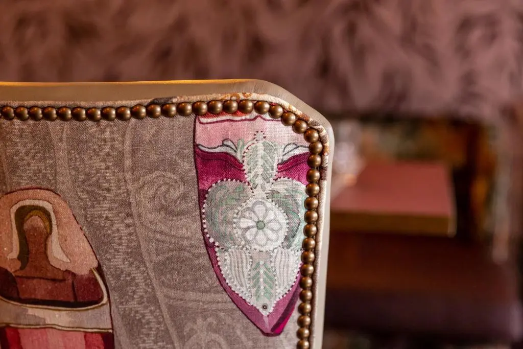 a close up of the back of a chair with a crest at Hotel 1881 of Speyside in Archiestown