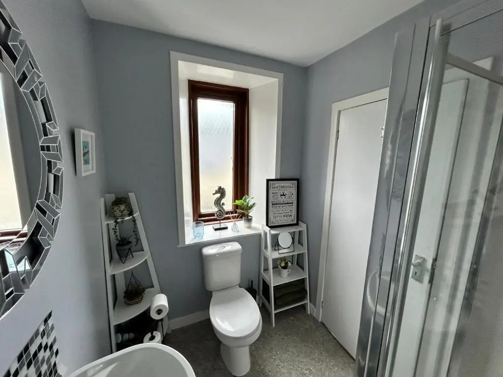 a bathroom with a toilet and a sink and a shower at St Duthus Hotel in Tain