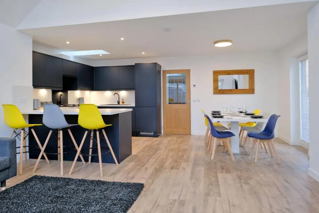 a kitchen and dining room with a table and chairs at Contemporary Luxury Lodge, Aberdeen West in Blackburn