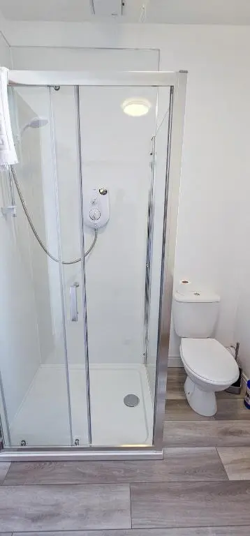 a bathroom with a shower and a toilet at Melrose Villa 11 Bedroom House in Inverness