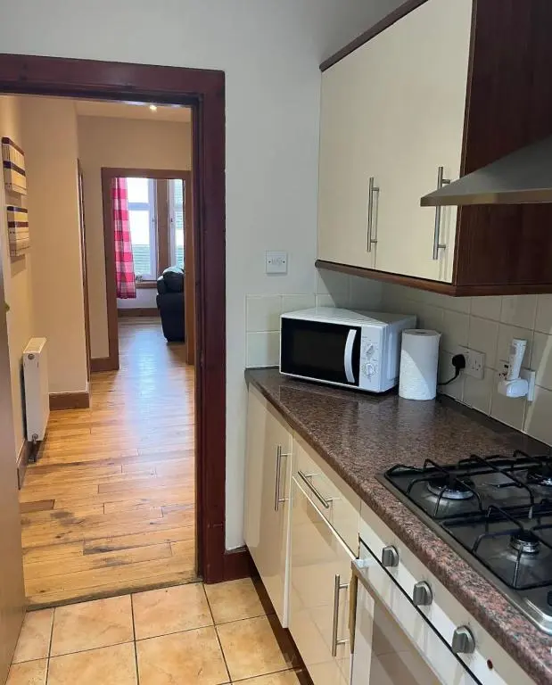 a kitchen with a microwave and a counter top at MacIver City Apartment Academy Street in Inverness