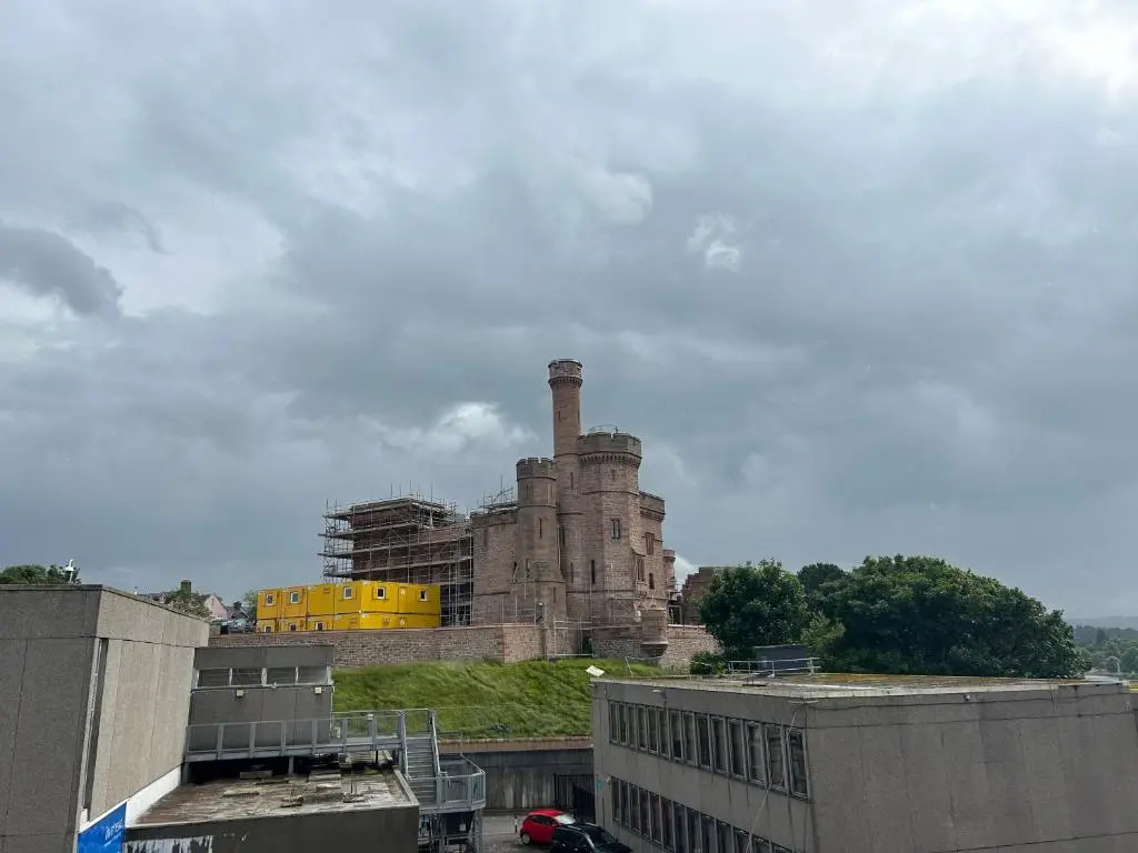 an old brick building on top of a hill at 1 Bedroom Castleview Apartment 404-Free Parking in Inverness