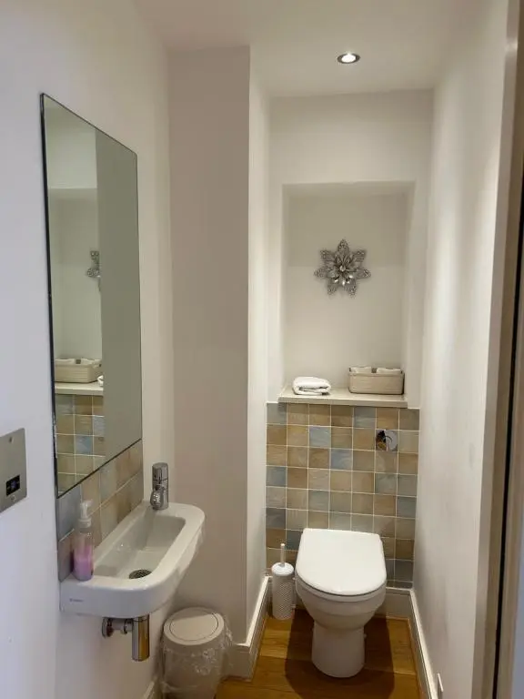 a bathroom with a white toilet and a sink at 1 Bedroom Castleview Apartment 404-Free Parking in Inverness