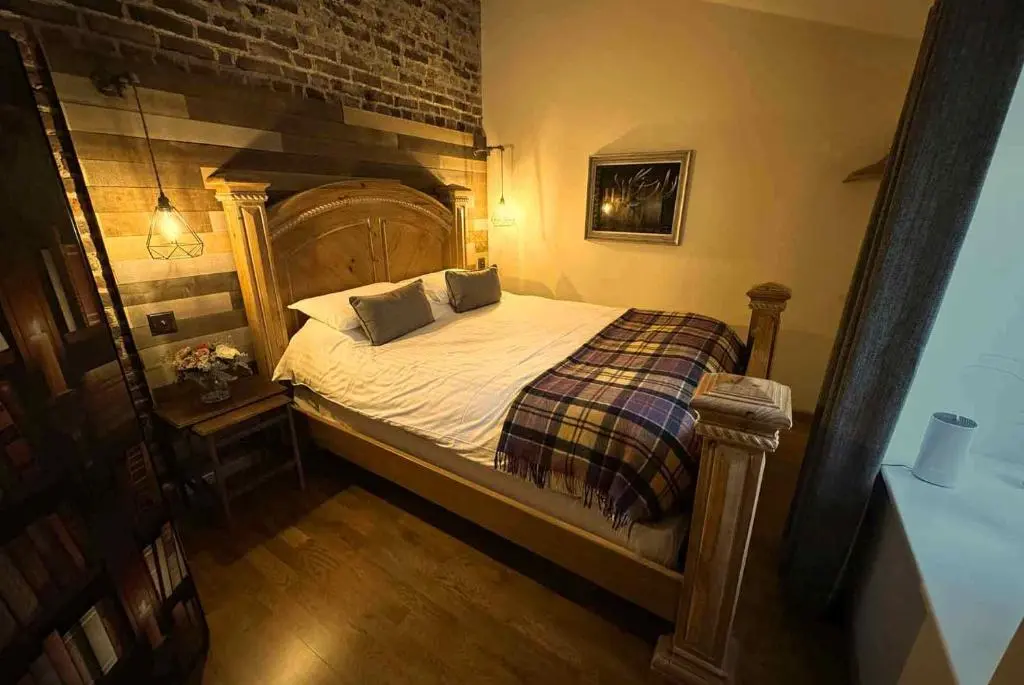 a bed with two pillows on it in a bedroom at The Potted Pineapple in Oyne