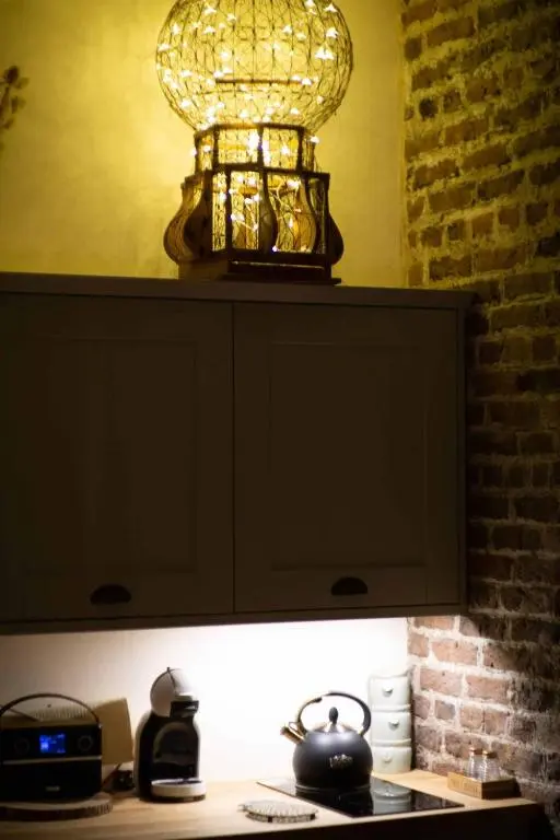 a light on top of a cabinet with a tea kettle at The Potted Pineapple in Oyne